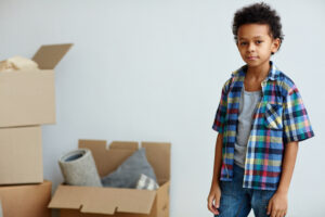 child moving boxes